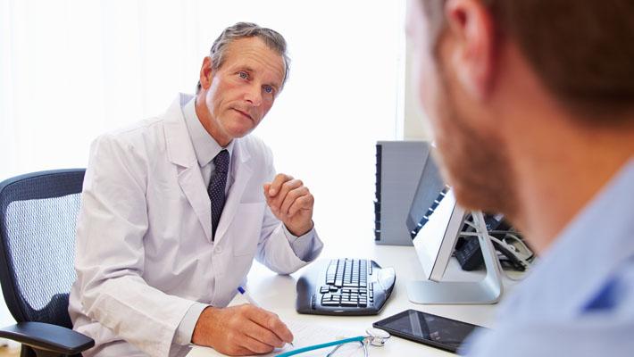 Male Patient Having Consultation With Doctor In Office