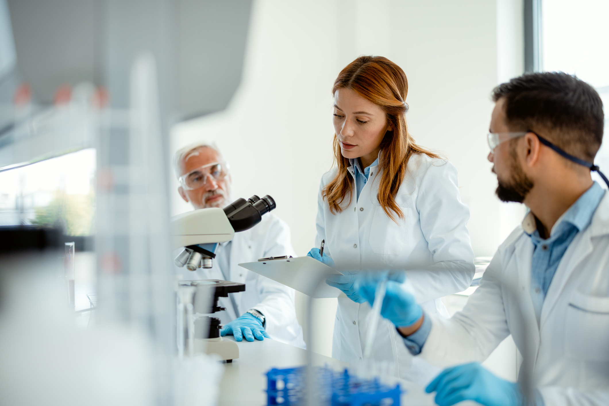 Team of Scientists Analyzing Chemical Reactions in Lab