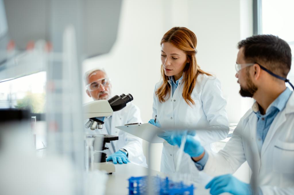 Team of Scientists Analyzing Chemical Reactions in Lab