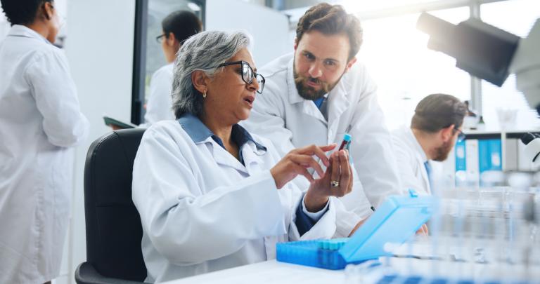 People, scientist and vial with blood sample for exam, text or experiment for medical research. Woman, man or scientific team with DNA for forensic investigation, diagnosis or genetic analysis in lab