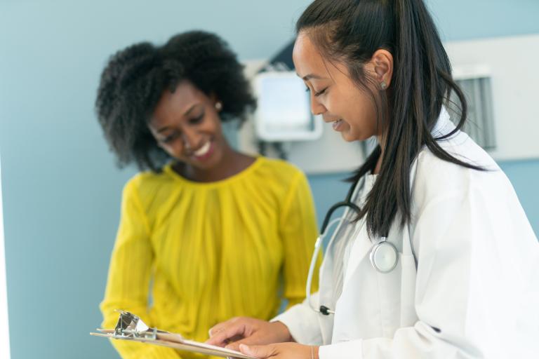 Ethnic woman in medical consultation with female doctor