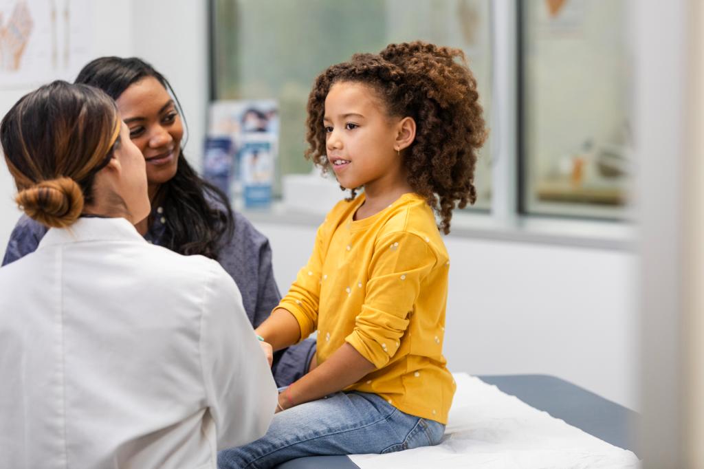 Young female patient talks to her doctor about her symptoms
