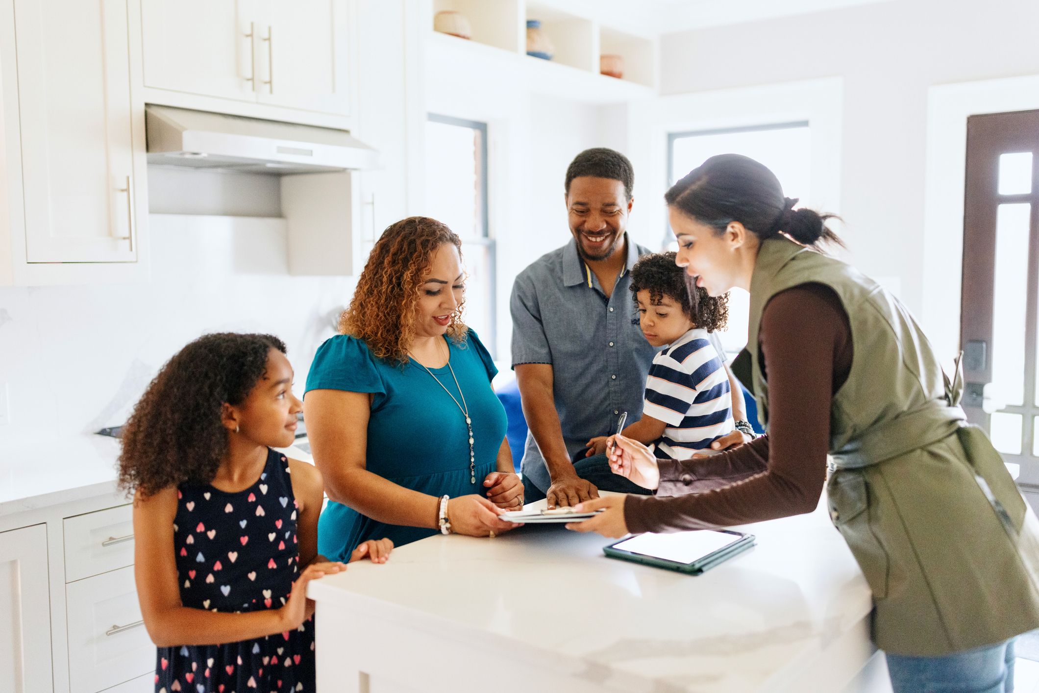 Excited American family signing the agreement on buying a house