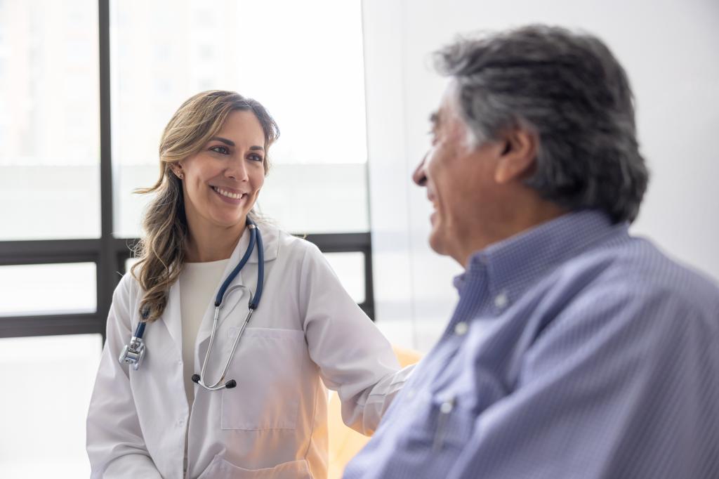 Doctor at the hospital talking to a patient in the waiting room